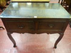 An 18th Century oak peg jointed two drawer lowboy having simple features with wavy apron on wavy