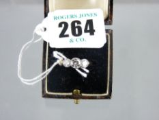 An eighteen carat gold dress ring having three round cut diamonds of visual estimate 0.3, 0.65 and