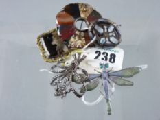 A multi agate circular brooch, an oval Celtic style brooch and another, a marcasite floral brooch