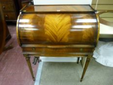 A reproduction crossbanded mahogany lady's cylinder bureau with slide-out red gilt tooled work