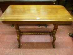 A Victorian mahogany side table having a rectangular top on turned supports with cross stretcher