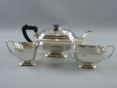 A heavy three piece silver tea service of plain oblong form, each piece on a stepped pedestal, 38