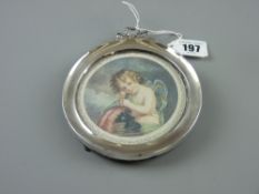 A circular silver easel portrait frame, 9.5 cms diameter with ribbon top, Birmingham 1906