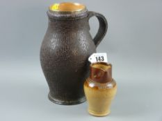 A Doulton Lambeth stoneware leatherware bulbous tankard with hallmarked silver rim, 22 cms high; a