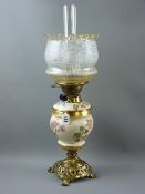 A Royal Worcester blush decorated and brass oil lamp, the pierced brass base with mask corners and