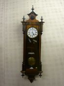 A walnut and ebony cased Vienna twin weight regulator wall clock, 132 cms overall height,