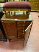 A Victorian two door mahogany collector's cabinet with six interior sliding drawers on block and