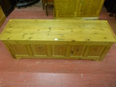 A stripped pine dower chest having five front inset and moulded panels, 139 cms wide