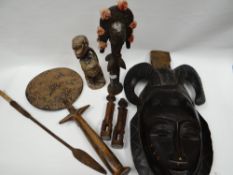 A parcel of exotic native carved figures and masks etc