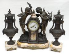 A French spelter and pink marble clock garniture. With two dancing cherubs flanking the raised