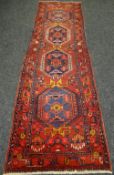 Red ground large Persian Herzi, 335 x 100 cms