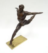 A bronze sculpture of Mikhail Baryshnikov in arabesque position mounted to a bronze platform base,