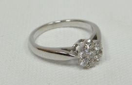 An 18k white gold seven-diamond floral-cluster ring, 0.5ct total (with accompanying laboratory