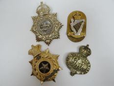 Four regimental helmet plates