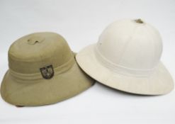 Two pith helmets to include a reproduction Africa Korps solar hat