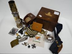 An artillery shell crested with regimental insignia together with an EPNS sugar cellar with RAF