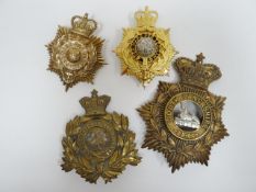Four regimental helmet plates