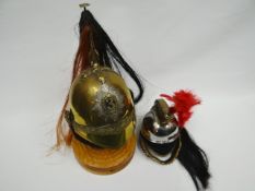 A half-size 3rd Dragoon Guards helmet with plumage and wooden stand together with French