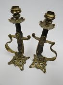 Two candlesticks fashioned from Imperial German Lion's head sword hilts
