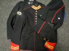 Two black tunics together with a pair of parade trousers