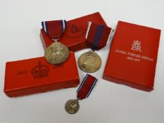 A 1935 Coronation Medal with miniature in box of issue together with a 1953 Coronation Medal in