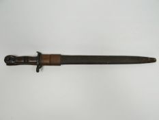 A 1917 US Remington bayonet in scabbard with leather frog together with ivory coloured oriental