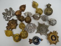 A quantity of assorted regimental cap badges, shoulder titles and collar badges