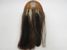 A regimental horsehair sporran with London Scottish badge