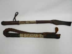 Two Middle Eastern mother-of-pearl inlaid ivory-coloured handled leather whips