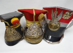 Three Lancers helmets with plates, chinscale straps and decorative braid tassles