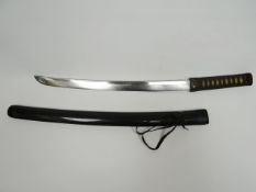 A Japanese wakisashi with gilt inlaid fittings craved decorative metal tsuba and bound rayskin