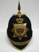 A blue cloth helmet with yellow metal fittings and lining marked 'Humphries & Crook, Haymarket,