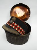 A Victorian Scottish officer's peaked cap in its metal case