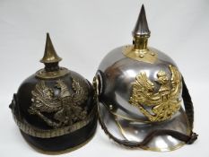 Two Imperial German pickelhaube-style helmets, one a copy of an Imperial Guard's