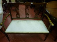 An Edwardian inlaid mahogany two seater couch with shaped back rail with line inlaid decoration over