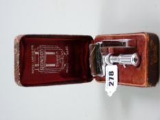 A cased Ronson 'Shaves and Sharpens' razor with slot for accompanying blade holder