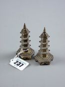 A pair of Oriental silver hexagonal based pepperettes in the form of pagoda towers, 1.9 ozs