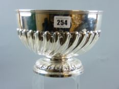 A circular silver pedestal bowl, the body with raised fluting, 20 cms diameter, 14 cms high, 19 ozs,