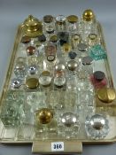 Approximately forty glass square based inkholders, mostly with lids along with a brass inkwell etc
