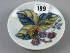 A Moorcroft Blackberry pin dish, mottled light blue ground, blue underglaze impressed marks, 11.5
