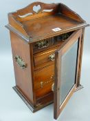 A circa 1910 mahogany smoker's cabinet with pierced gallery top and swing carrying handles, the