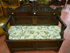 A late Victorian mahogany box seat hall bench with leaf and berry carved scroll work rail, reeded