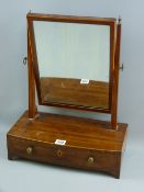 A Regency mahogany and boxwood strung swing toilet mirror on bow fronted single drawer base with