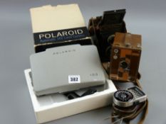 A Beau Brownie box camera, a cased Rolleicord 2.25 square camera, a boxed Polaroid automatic 103