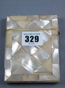 A mother of pearl card case with end hinged lid and silver mounted lid