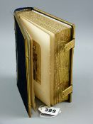 A brass bound velvet covered photograph album with metal clasps, tooled gilt edged pages,