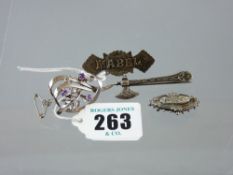 A silver scrolled and leaf brooch with three small amethysts, 5 grms, a silver Celtic style pike