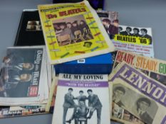 A parcel of Beatles memorabilia including sundry publications and including two Parlophone 45rpm