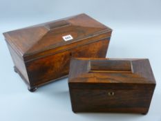 A Regency rosewood sarcophagus shaped tea caddy with brass escutcheon on turned bun feet having twin