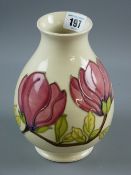 A Moorcroft Magnolia cream ground bulbous vase, impressed marks and painted 'WM' to the base, 19 cms